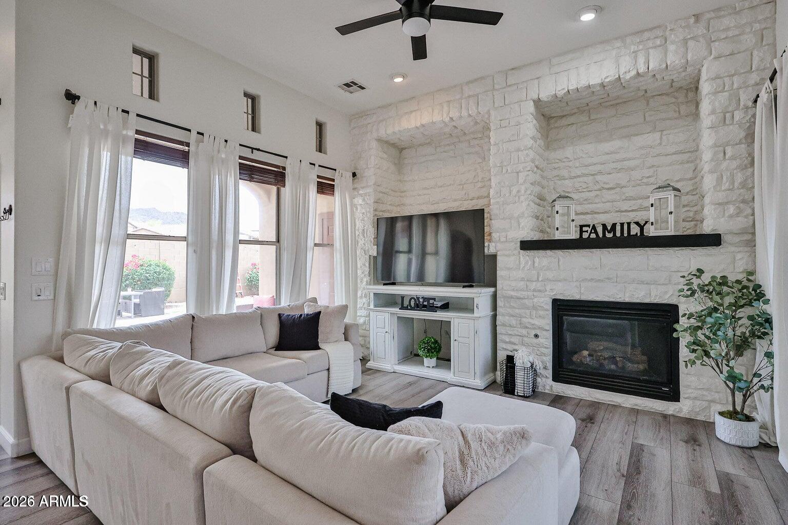 3950 North Edith Way Buckeye, AZ 85396 - Photo 16 of 32 a living room with furniture fireplace and window