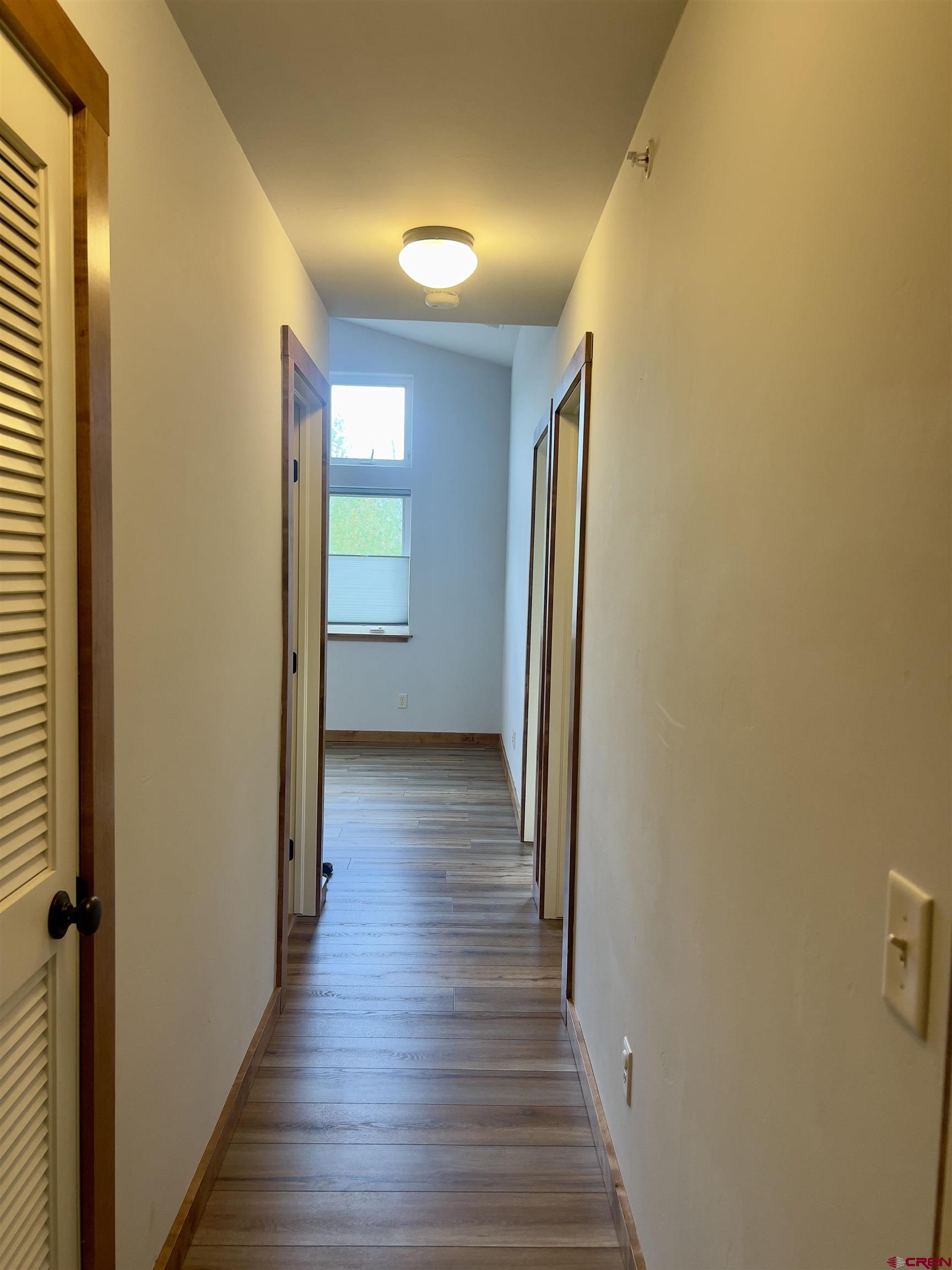 540 Redcliff Circle, Unit E 203 Ridgway, CO 81432 - Photo 27 of 36 a view of a hallway with wooden floor