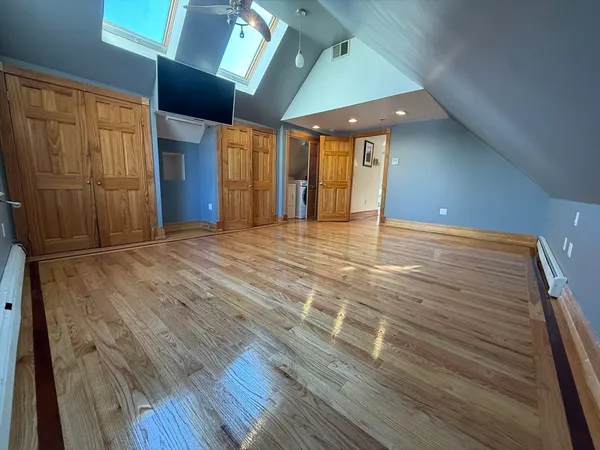 a view of an empty room with wooden floor
