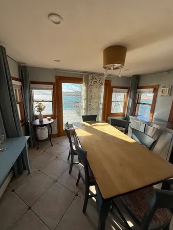 a view of a dining room with furniture and a large window