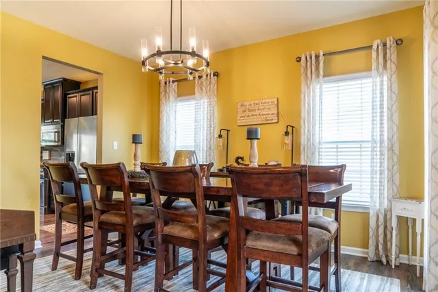 a view of a dining room with furniture and chandelier