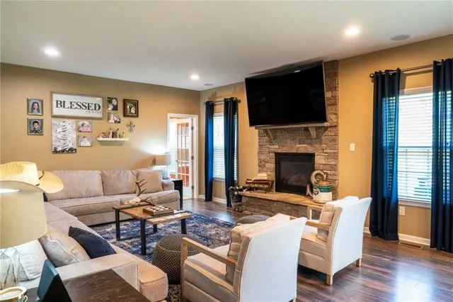 a living room with furniture fireplace and a flat screen tv