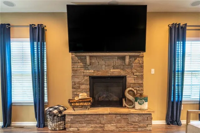 a living room with fireplace and a fireplace