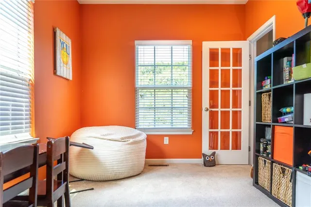 a bed sitting in a bedroom next to a window