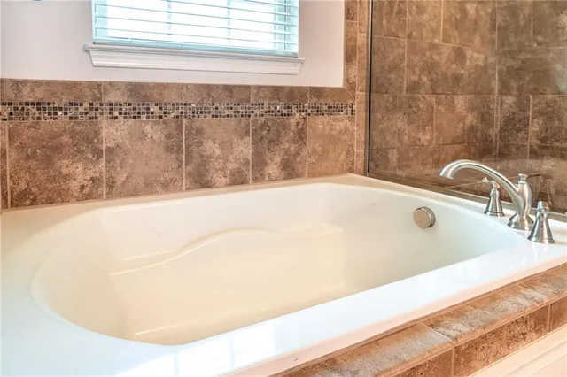 a bathroom with a granite countertop sink and a large mirror