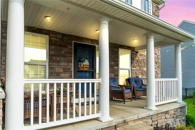 a view of porch with a bench and floor to ceiling window