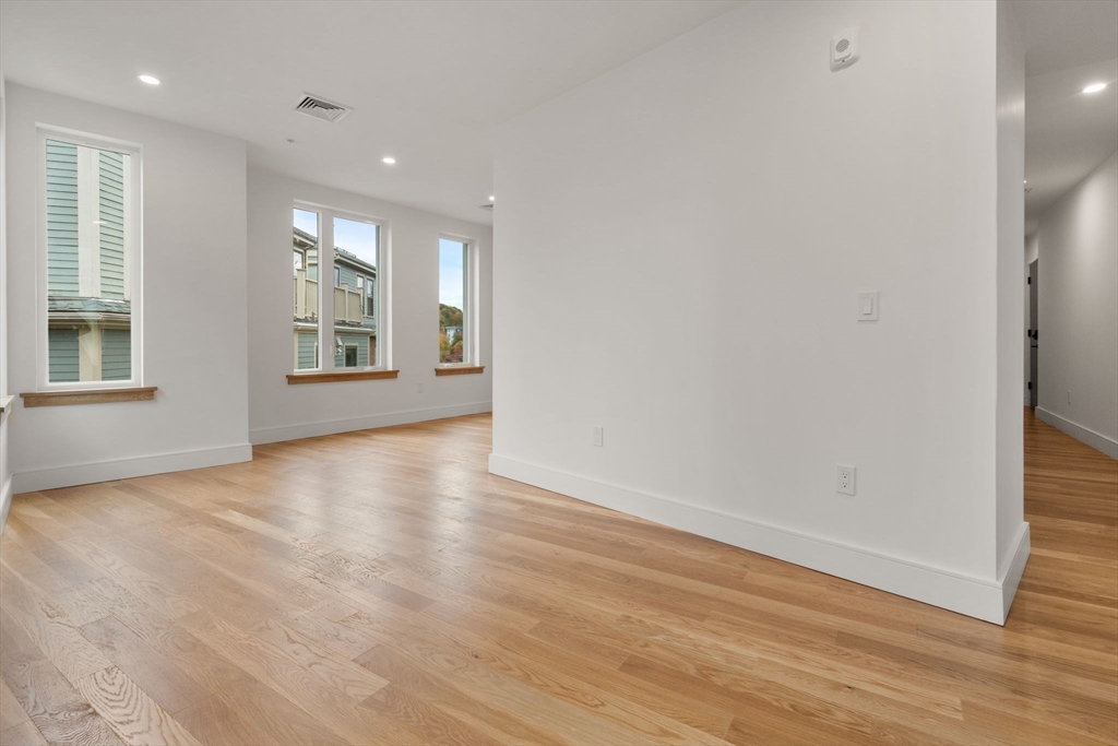 58 Kent, Unit 304 Brookline, MA 02445 - Photo 9 of 19 wooden floor in an empty room with a window