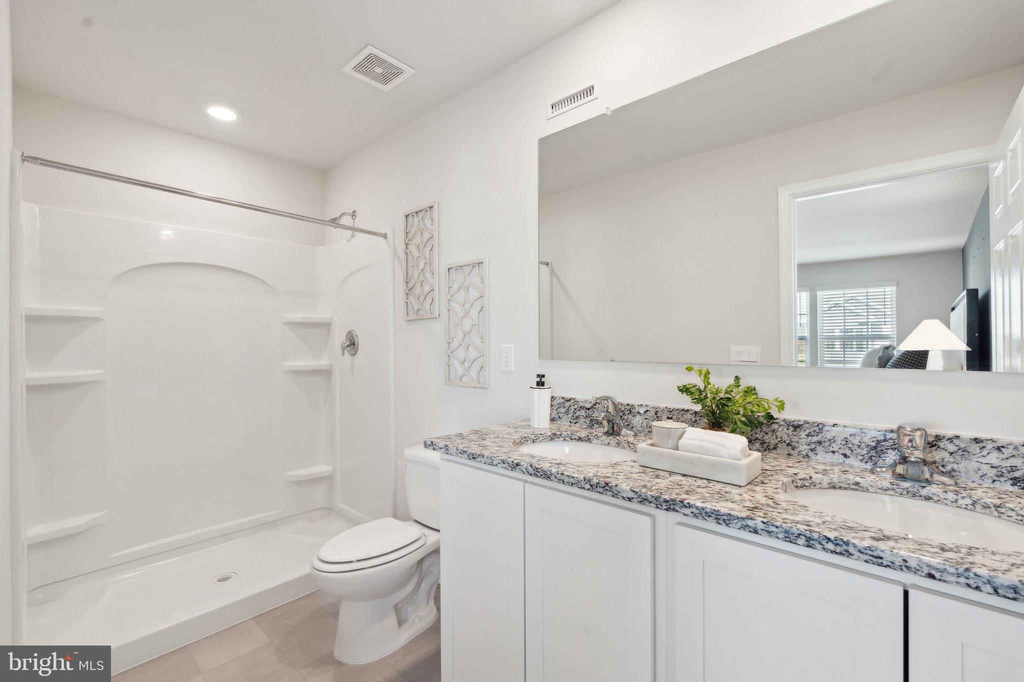 128 Rae Court Luray, VA 22835 - Photo 25 of 30 a bathroom with a granite countertop sink a toilet and shower