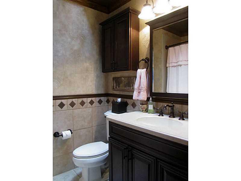 120 South Camp Run Road Fombell, PA 16123 - Photo 12 of 25 Full Bath. Full hall bath with tub/shower with corian surround, ceramic floor and half walls with chair rail, bronze fixtures, stained cabinet, crown molding, skylight. Large linen closet in hall.