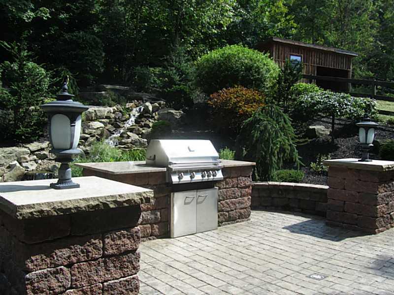 120 South Camp Run Road Fombell, PA 16123 - Photo 18 of 25 Yard/Garden. Back patio area with lights, gas grill, waterfall and pond, storage shed.