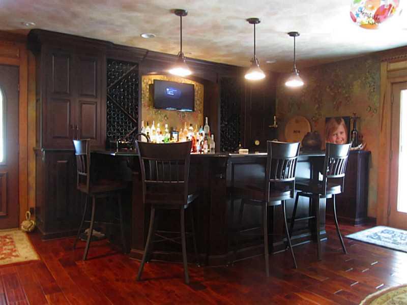 120 South Camp Run Road Fombell, PA 16123 - Photo 4 of 25 Great Room. Custom built cherry bar w/granite tops, copper sink, beverage refrigerator, full sized dishwasher, microwave, pendant lights. Bar counter overhang provides seating for four! French door to outdoor patio with hot tub. Lower cabinet by side door w/pullouts.