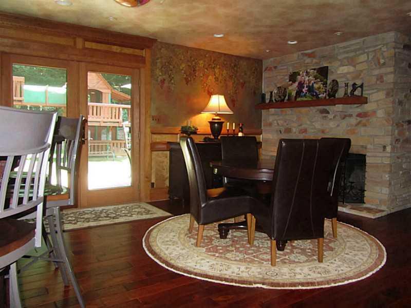 120 South Camp Run Road Fombell, PA 16123 - Photo 5 of 25 Great Room. Pub area with wide plank teak floor and stone, log burning fireplace. Glass French doors to back patio with hot tub (included). Recessed lights.