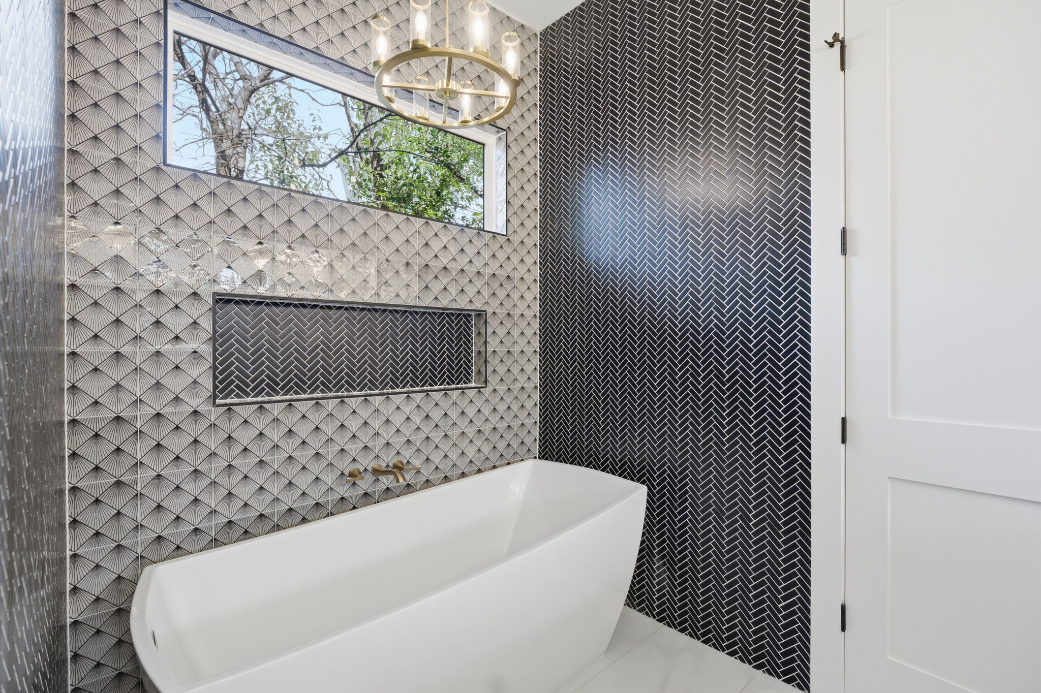 400 Post Rd Drive Austin, TX 78704 - Photo 13 of 23 Bathroom with a freestanding tub, hanging lights, and tile walls