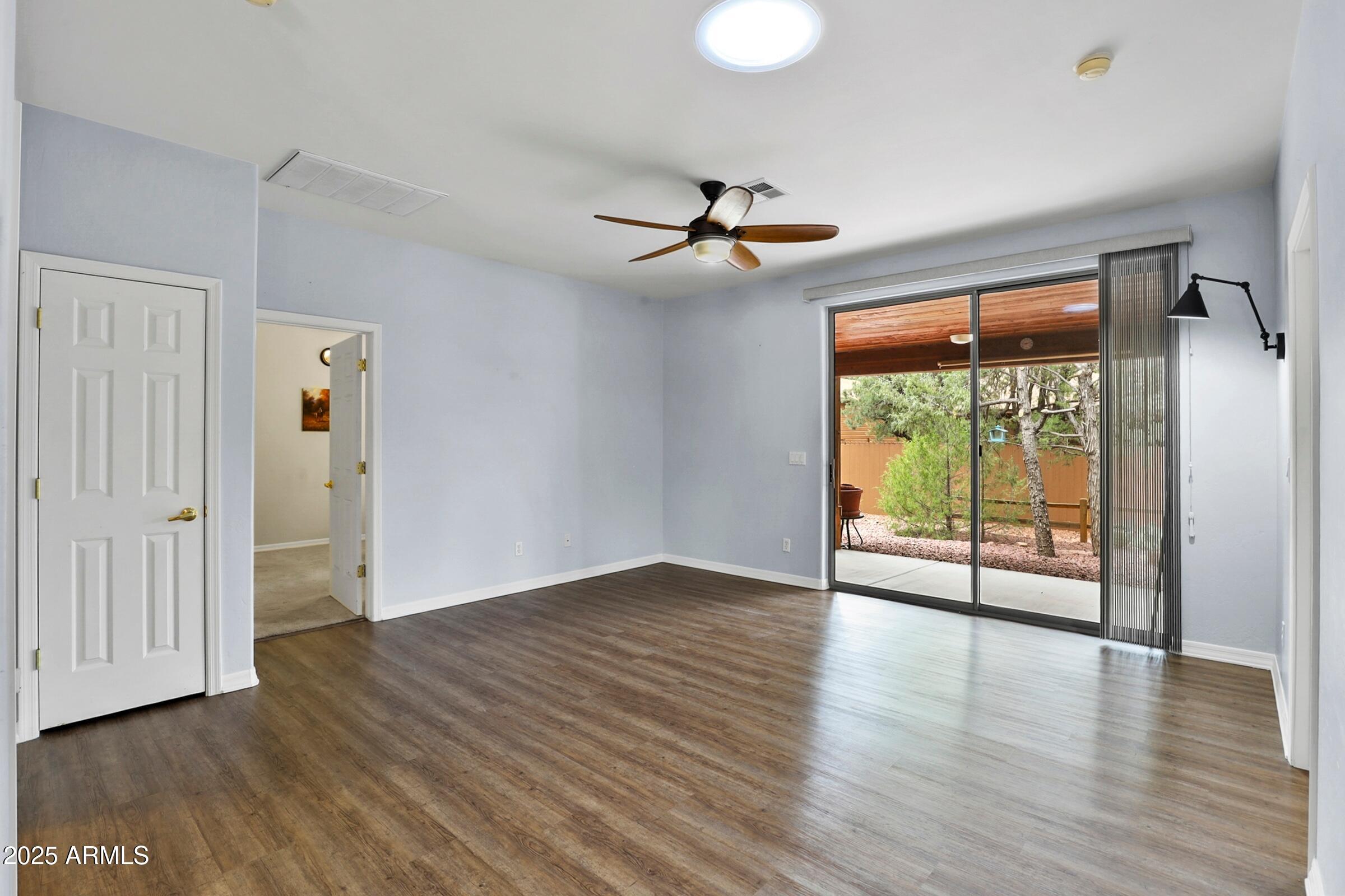 300 West Cody Circle Payson, AZ 85541 - Photo 11 of 25 an empty room with wooden floor fan and windows