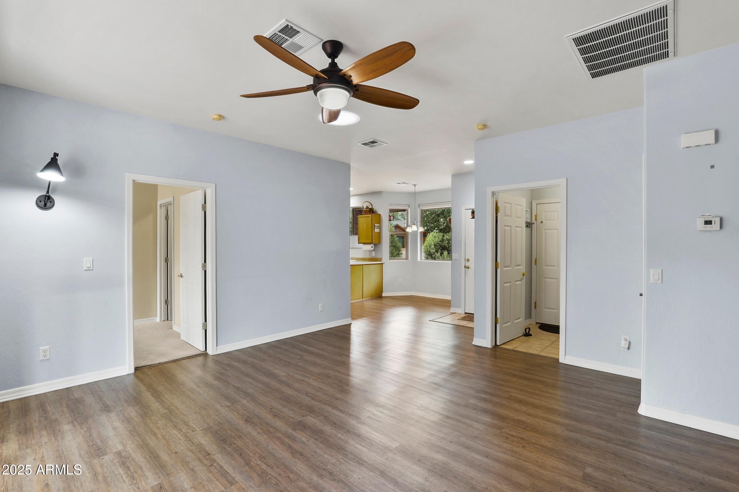 300 West Cody Circle Payson, AZ 85541 - Photo 12 of 25 a view of an empty room with wooden floor and a ceiling fan