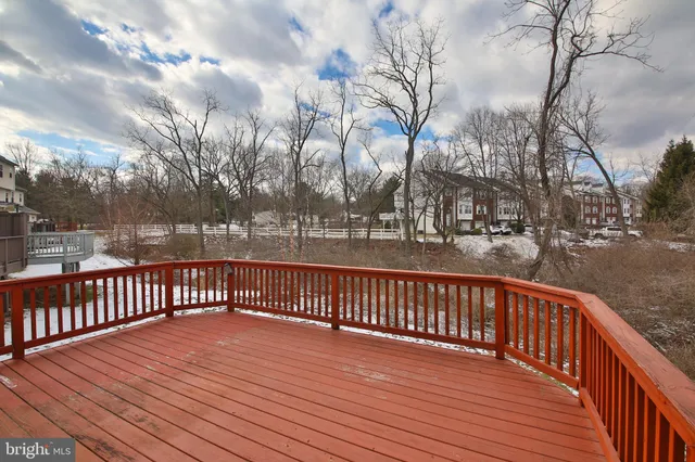 a balcony with wooden floor and fence