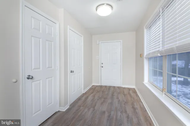 a view of a hallway with wooden floor