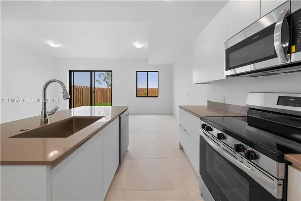 a kitchen with a stove and a sink