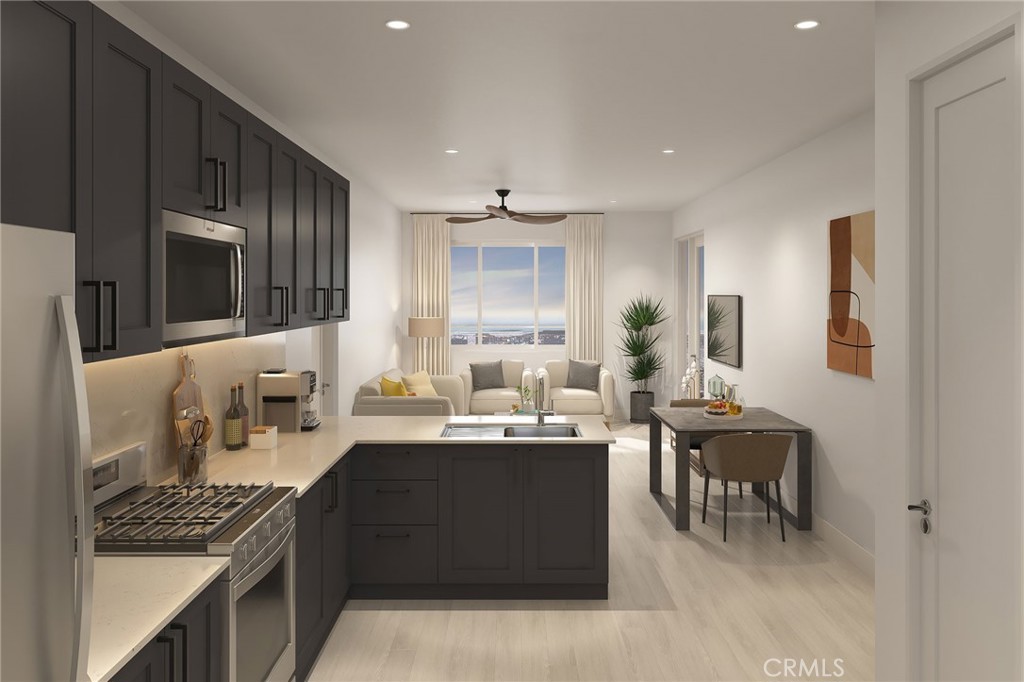 401 West Grand Avenue, Unit 307 Grover Beach, CA 93433 - Photo 4 of 9 a kitchen with stainless steel appliances kitchen island granite countertop a sink stove and cabinets