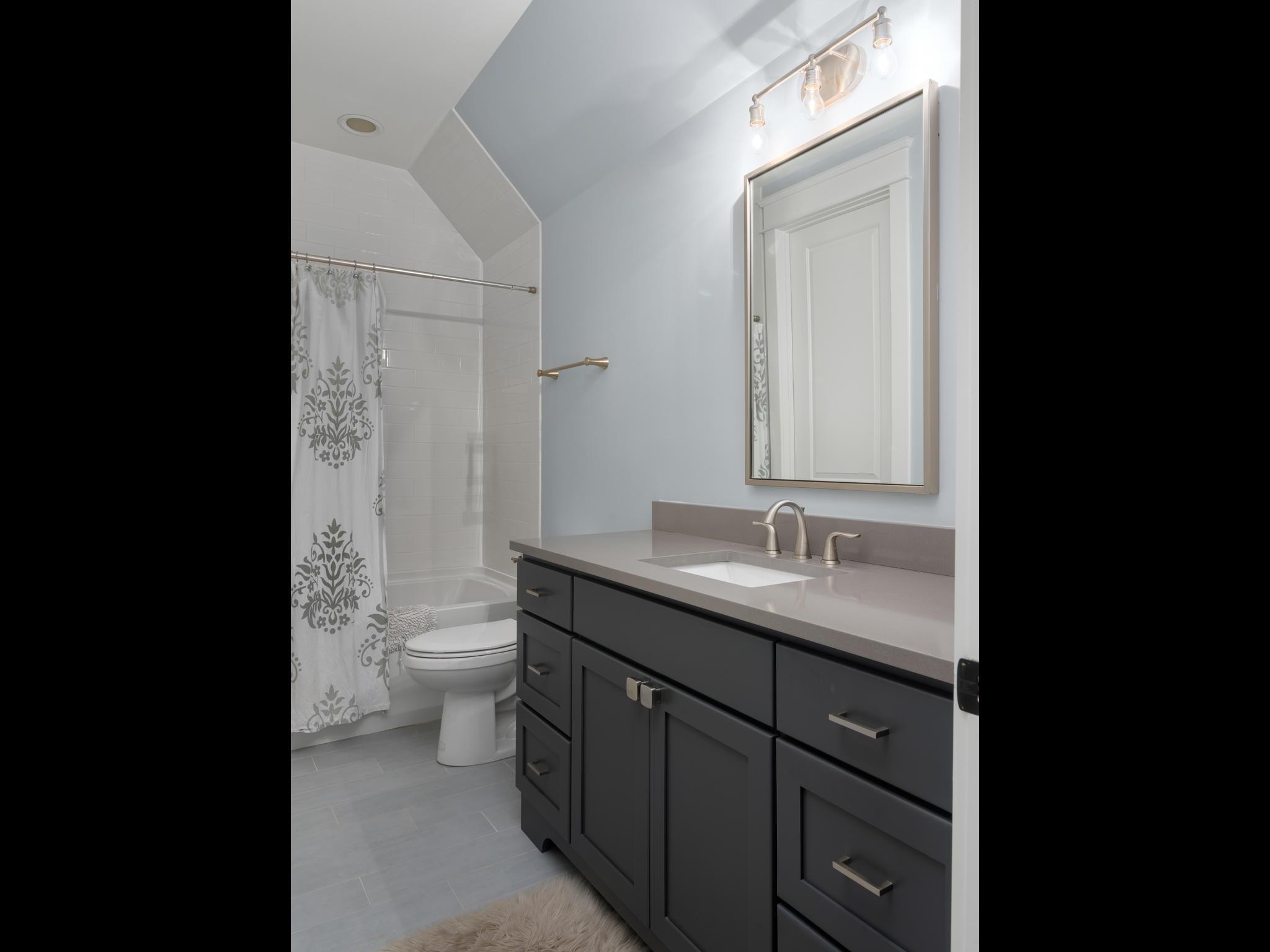 3520 Trimble Road Nashville, TN 37215 - Photo 30 of 44 a bathroom with a granite countertop sink a toilet and a mirror