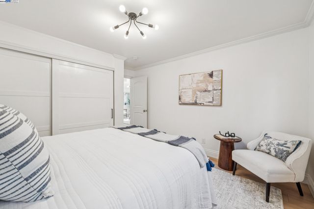 a bedroom with a bed and a couch