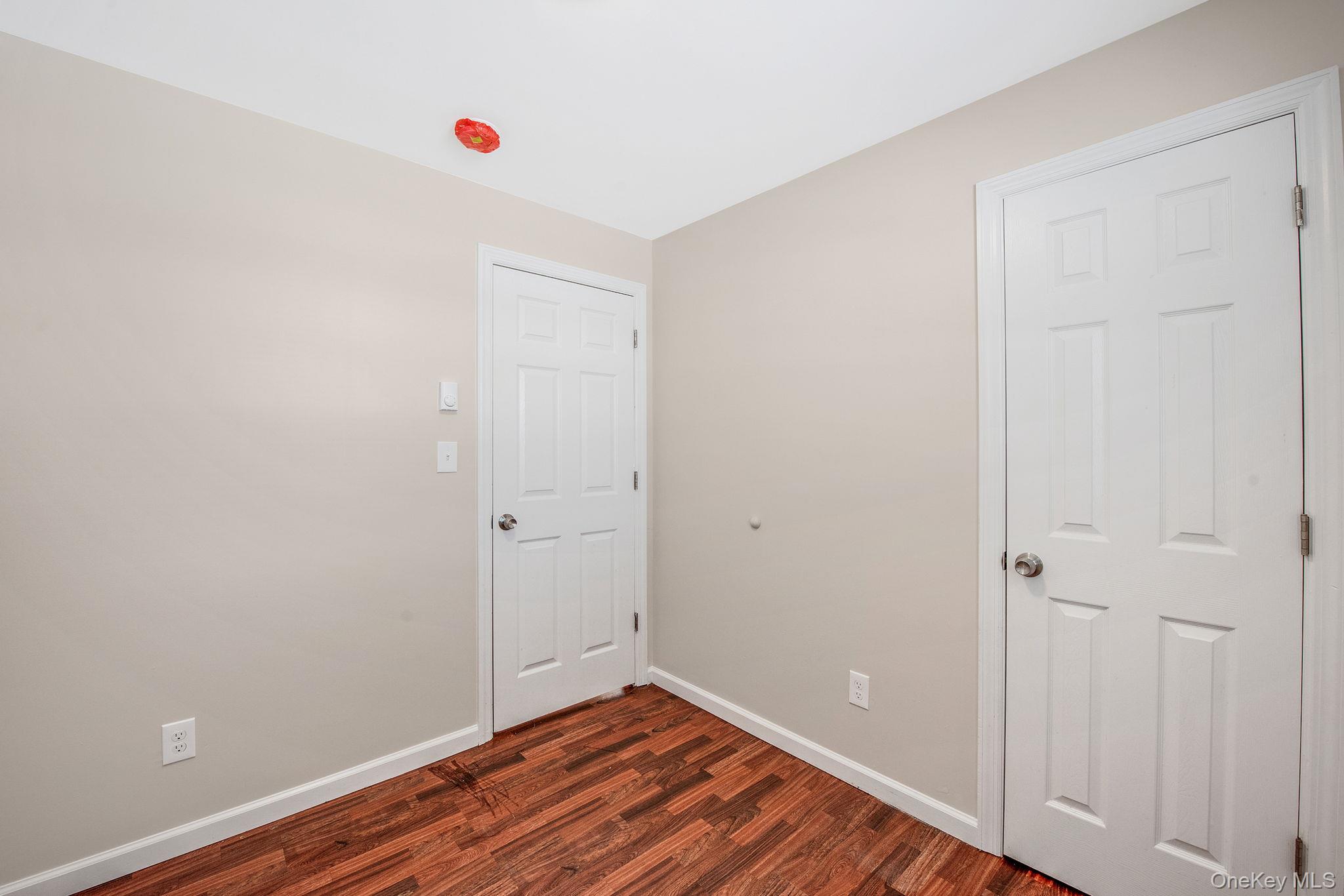 703 Provost Avenue Bellport, NY 11713 - Photo 11 of 16 wooden floor in an empty room