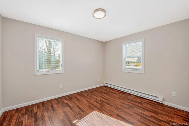 a view of a room with wooden floor and window