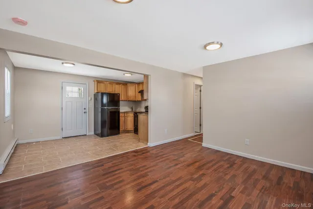 an empty room with wooden floor and closet