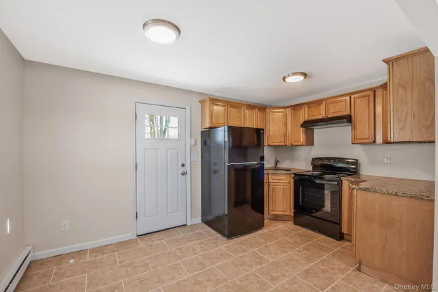 a kitchen with stainless steel appliances granite countertop a refrigerator stove and sink