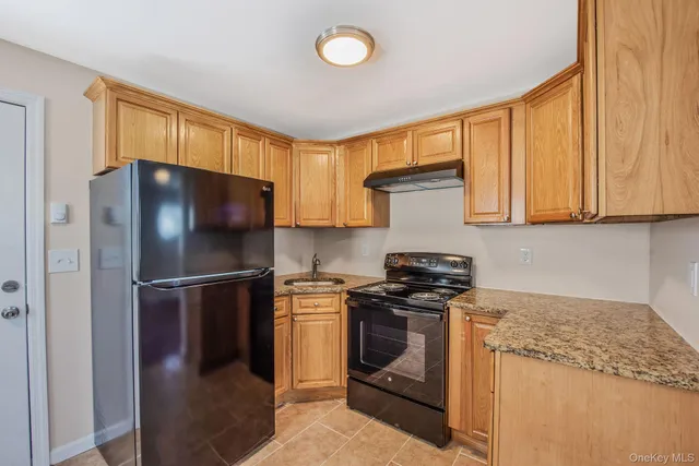 a kitchen with a stove a refrigerator and a sink