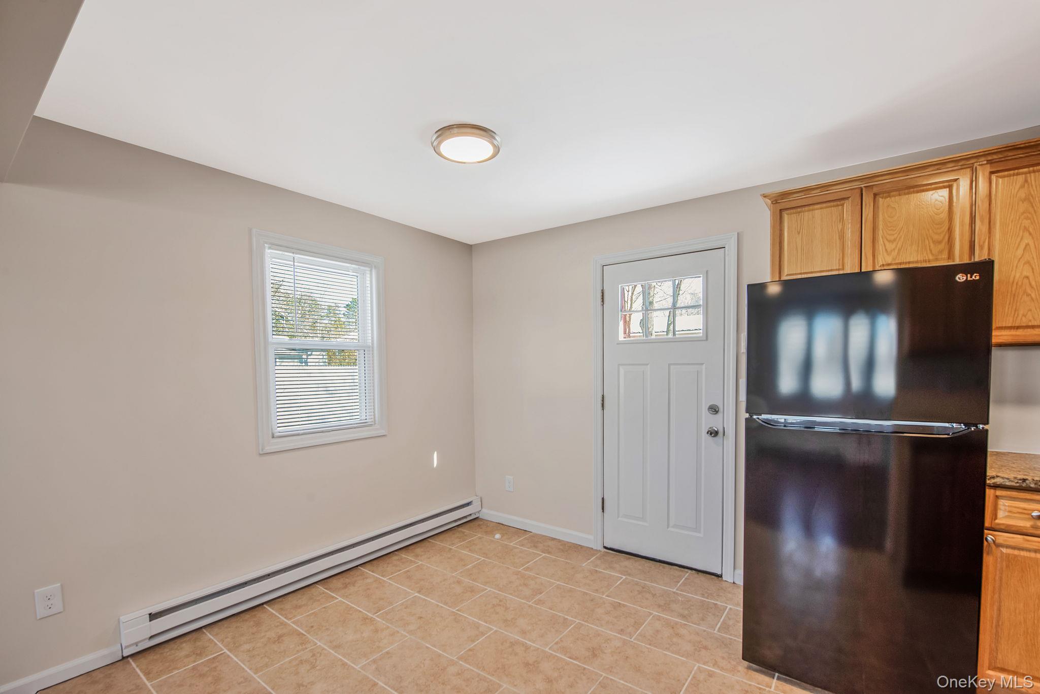 703 Provost Avenue Bellport, NY 11713 - Photo 8 of 16 a view of an empty room with a window