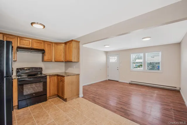a view of a kitchen with a sink stove and cabinets