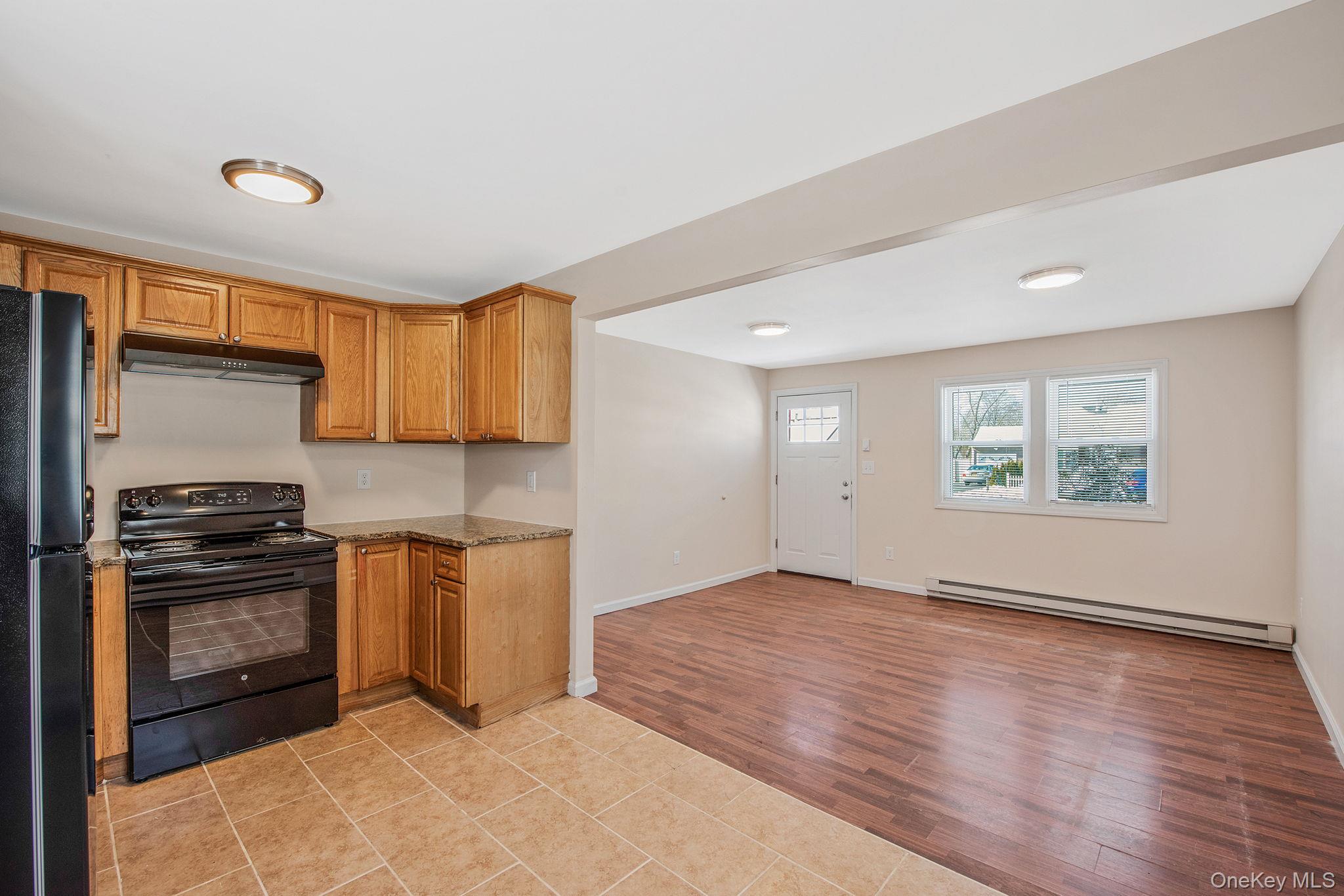 703 Provost Avenue Bellport, NY 11713 - Photo 9 of 16 a view of a kitchen with a sink stove and cabinets
