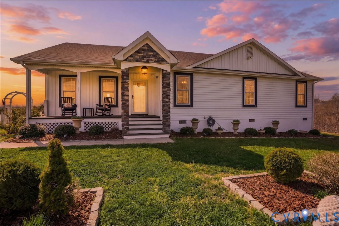 a front view of a house with a garden