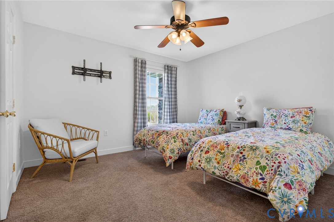 2092 Leigh Mountain Road Green Bay, VA 23942 - Photo 30 of 72 a bedroom with two beds and a chandelier