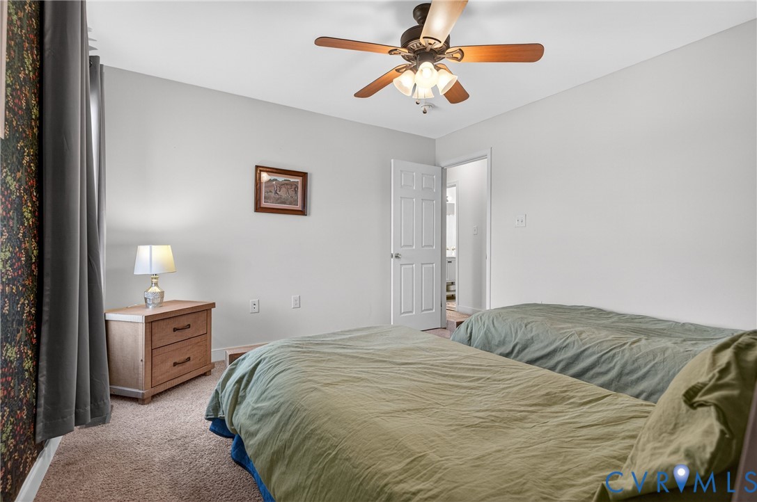 2092 Leigh Mountain Road Green Bay, VA 23942 - Photo 43 of 72 a bedroom with a bed and a chandelier