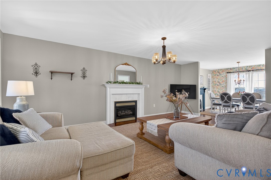2092 Leigh Mountain Road Green Bay, VA 23942 - Photo 51 of 72 a living room with furniture a fireplace and a chandelier