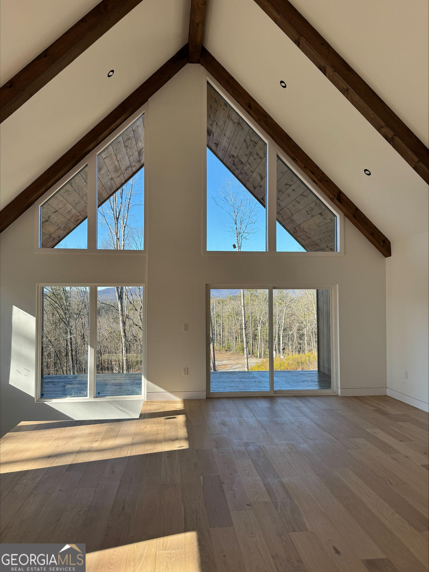 1705 Old Northcutt Road, Unit TR A Ellijay, GA 30536 - Photo 11 of 29 a view of an empty room with wooden floor and a window