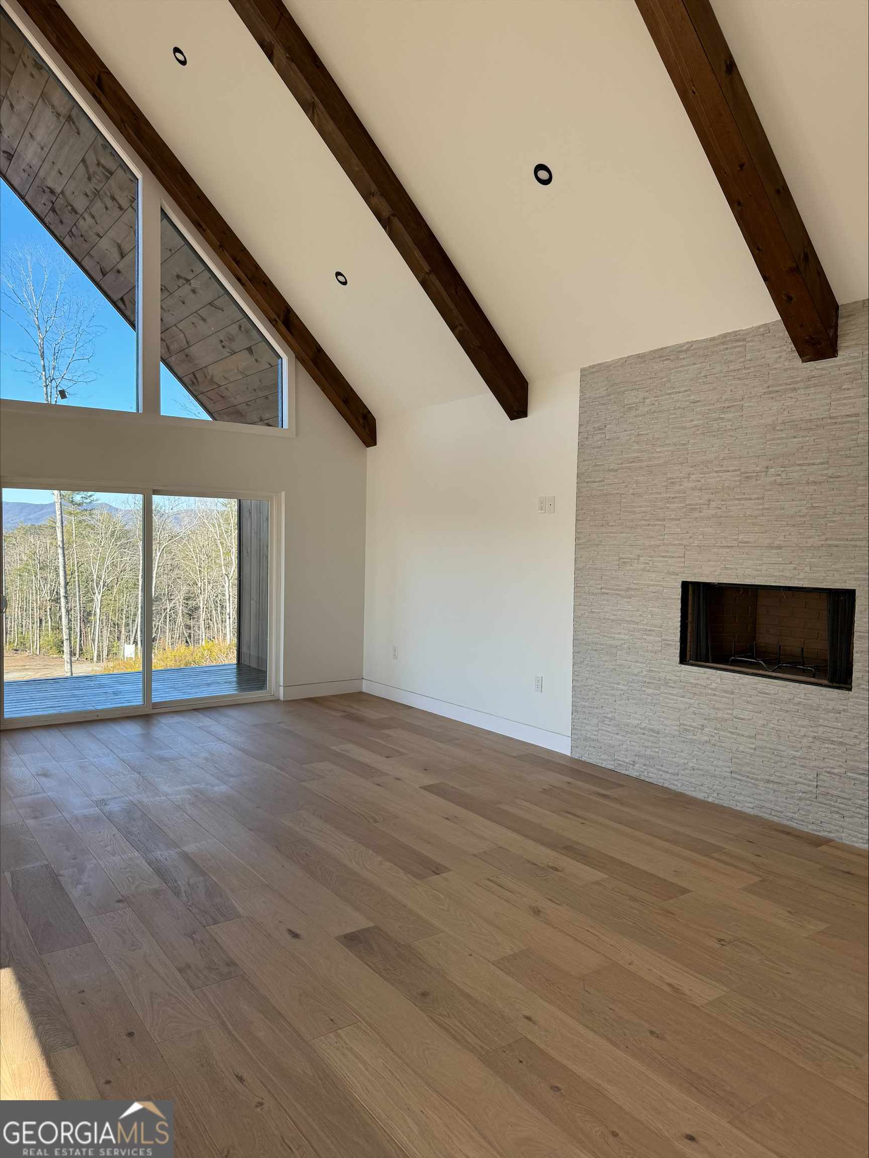 1705 Old Northcutt Road, Unit TR A Ellijay, GA 30536 - Photo 2 of 29 a view of an empty room with wooden floor and a window