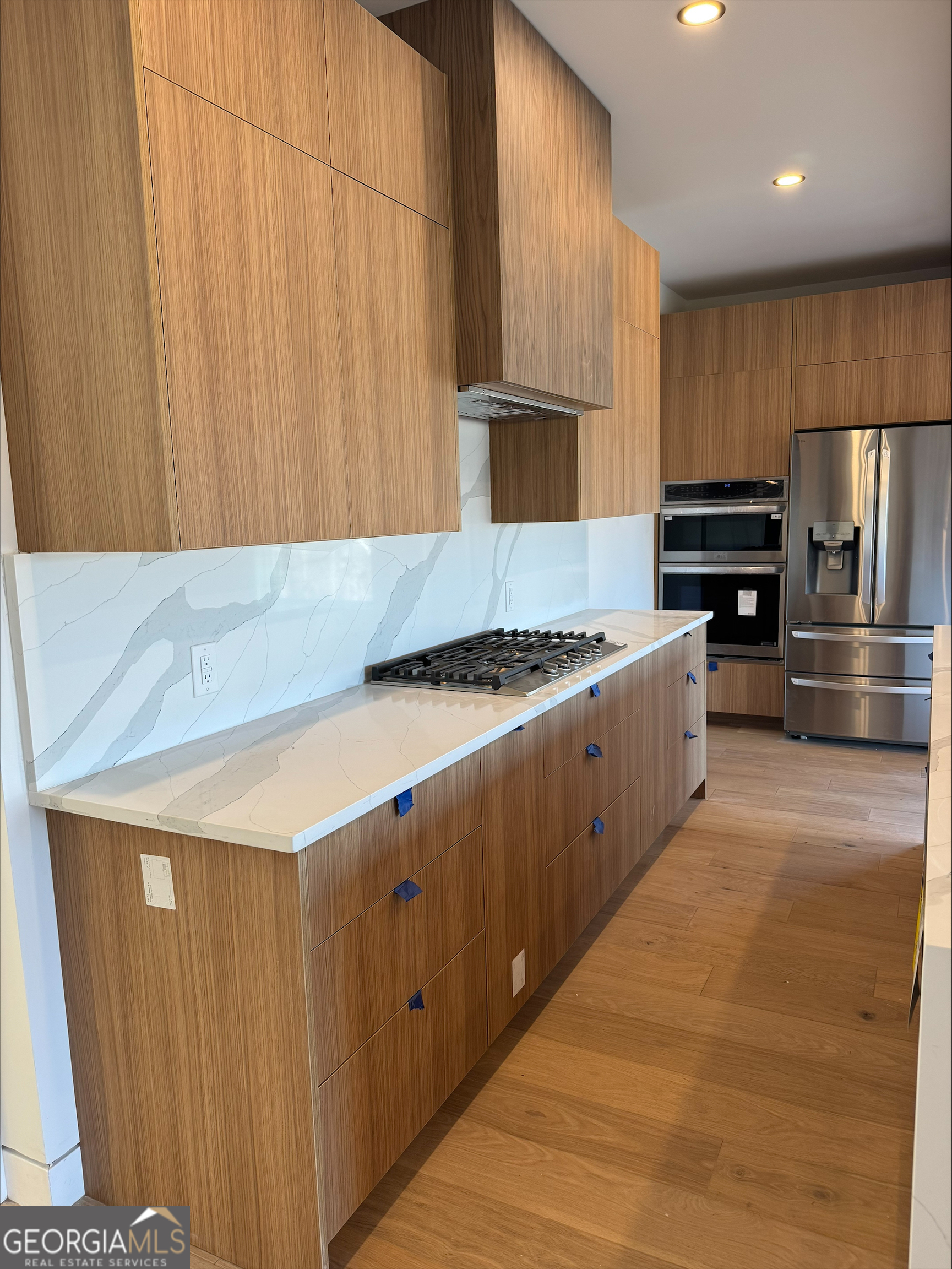 1705 Old Northcutt Road, Unit TR A Ellijay, GA 30536 - Photo 23 of 29 a kitchen with kitchen island granite countertop a sink and a stove
