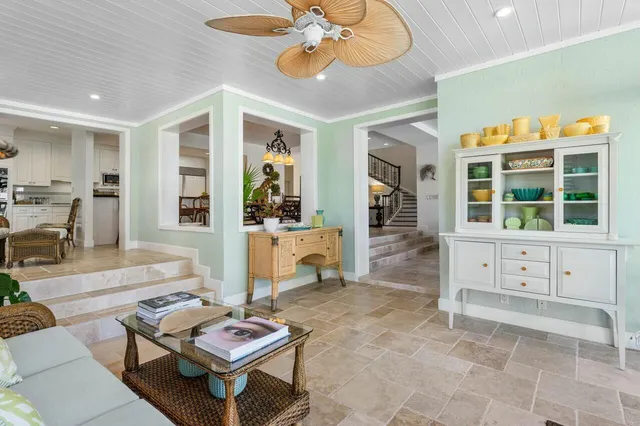 a living room with furniture and potted plants