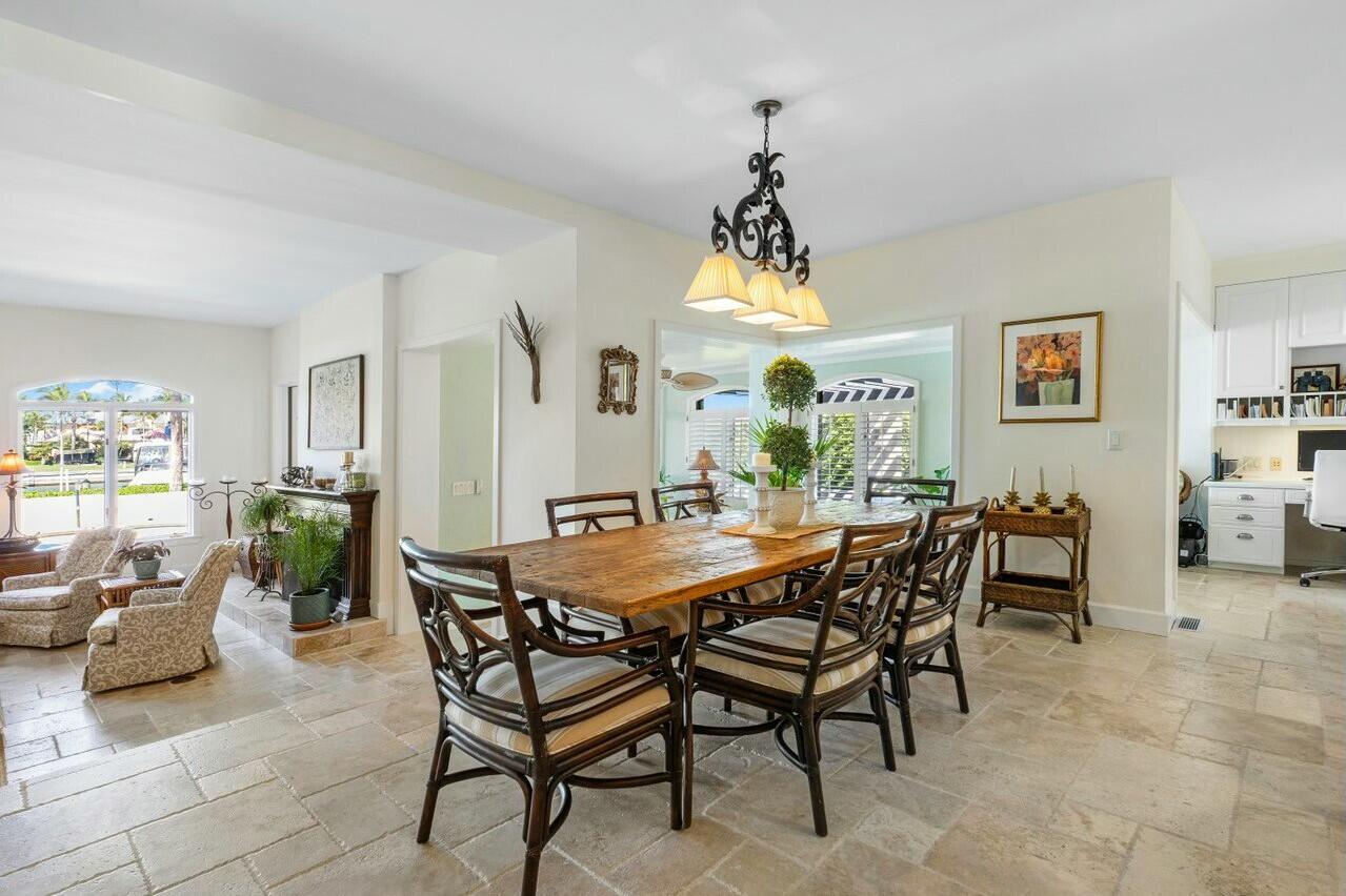 6549 Southeast South Marina Way Stuart, FL 34996 - Photo 18 of 76 a view of a dining room and livingroom with furniture wooden floor a chandelier