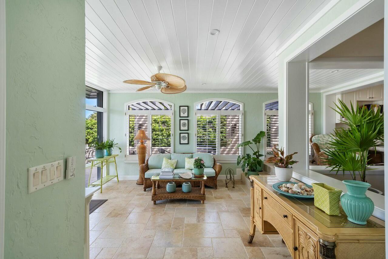 6549 Southeast South Marina Way Stuart, FL 34996 - Photo 19 of 76 a living room with furniture and potted plants
