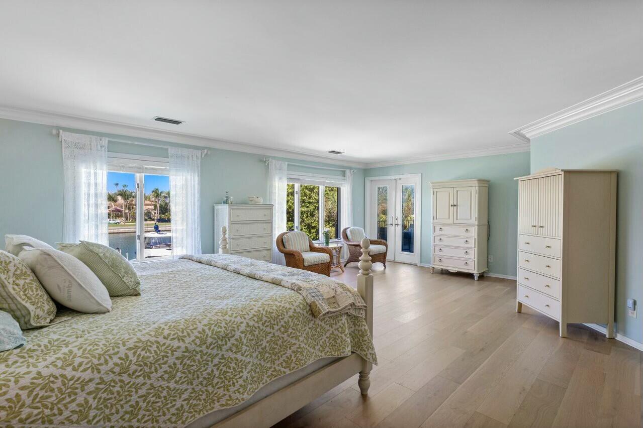 6549 Southeast South Marina Way Stuart, FL 34996 - Photo 21 of 76 a bedroom with a bed and a couch