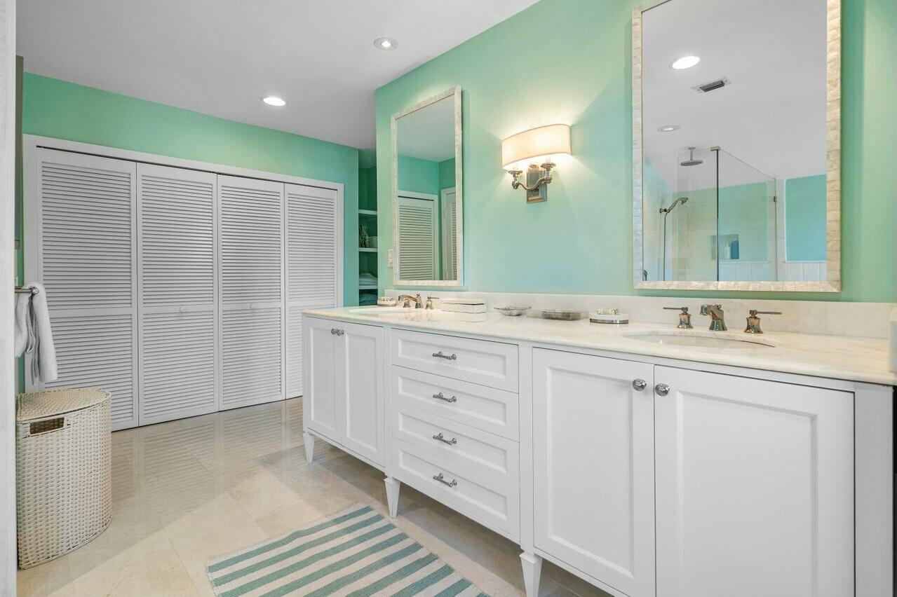 6549 Southeast South Marina Way Stuart, FL 34996 - Photo 29 of 76 a bathroom with a double vanity sink and a mirror