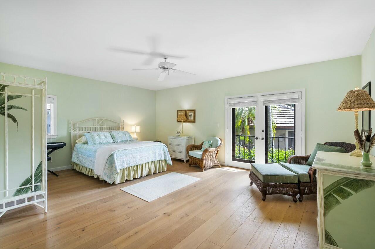 6549 Southeast South Marina Way Stuart, FL 34996 - Photo 40 of 76 a spacious bedroom with a bed and wooden floor
