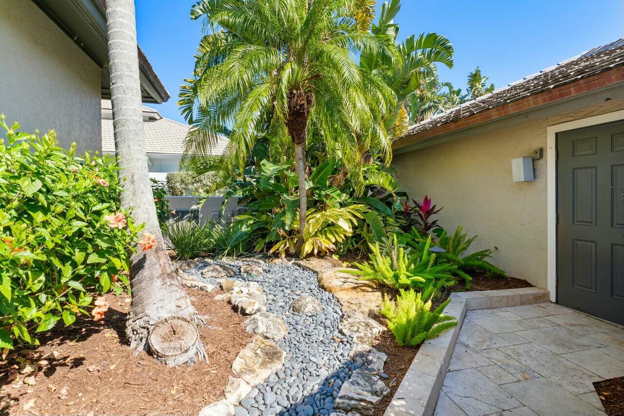 6549 Southeast South Marina Way Stuart, FL 34996 - Photo 56 of 76 a flower plants with potted plants in front of door