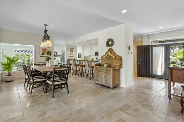 a living room with stainless steel appliances kitchen island granite countertop furniture and a refrigerator