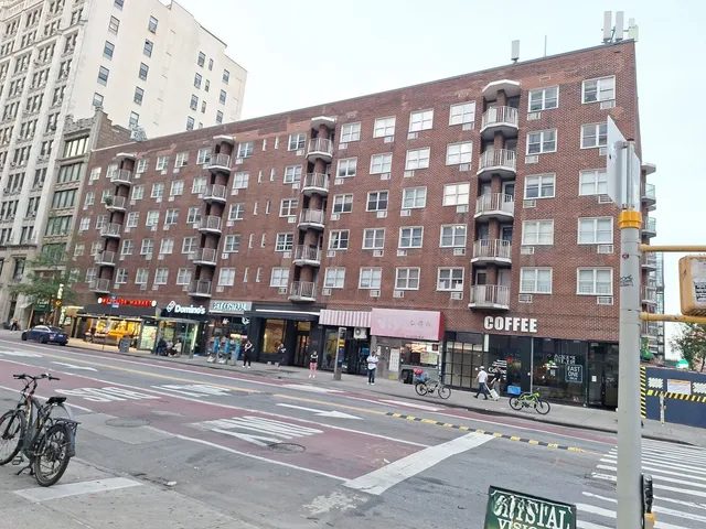 a city street lined with buildings and cars