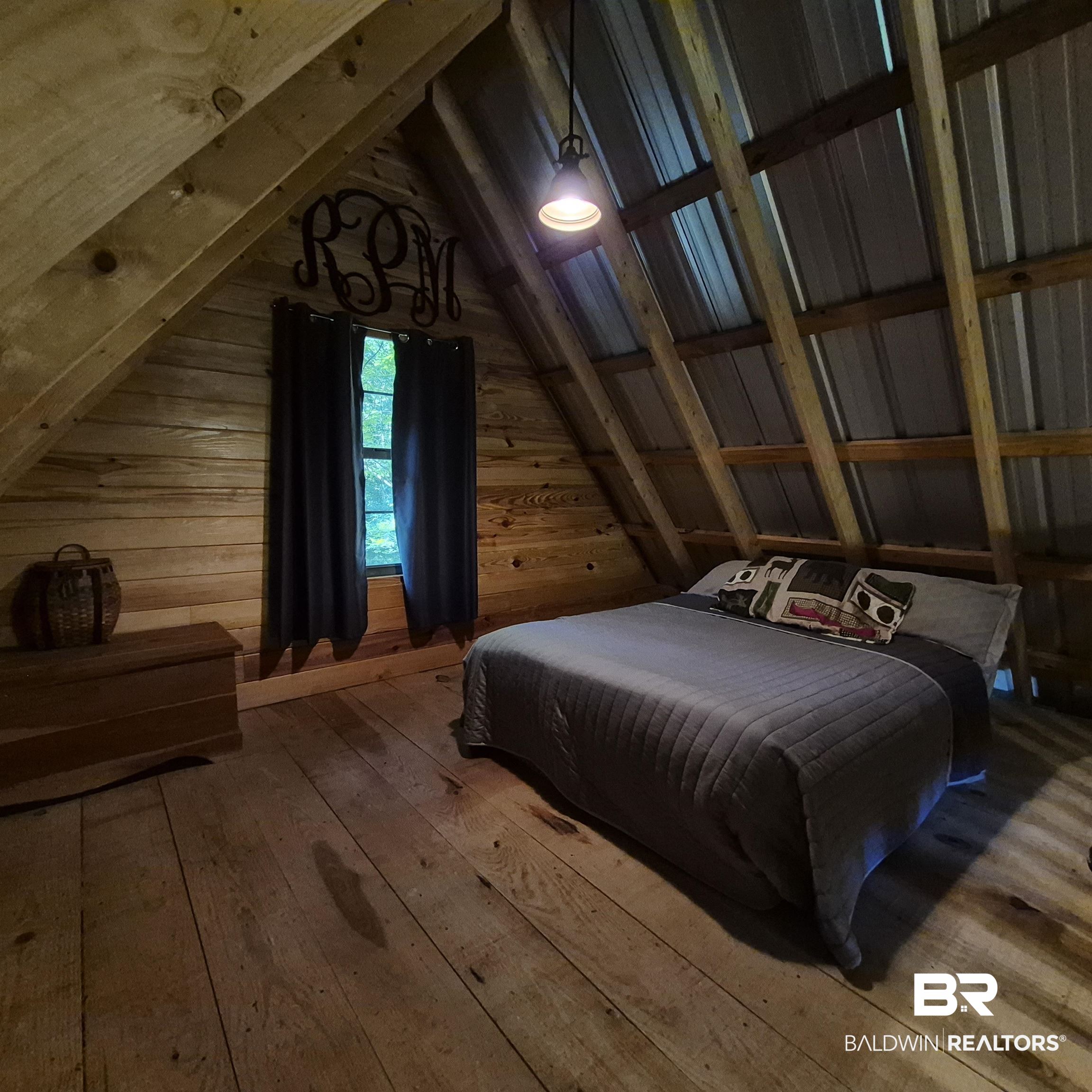 0 Eureka Landing Road Uriah, AL 36480 - Photo 10 of 27 Rustic attic space featuring exposed wood beams, wood-plank walls, and wood-plank flooring